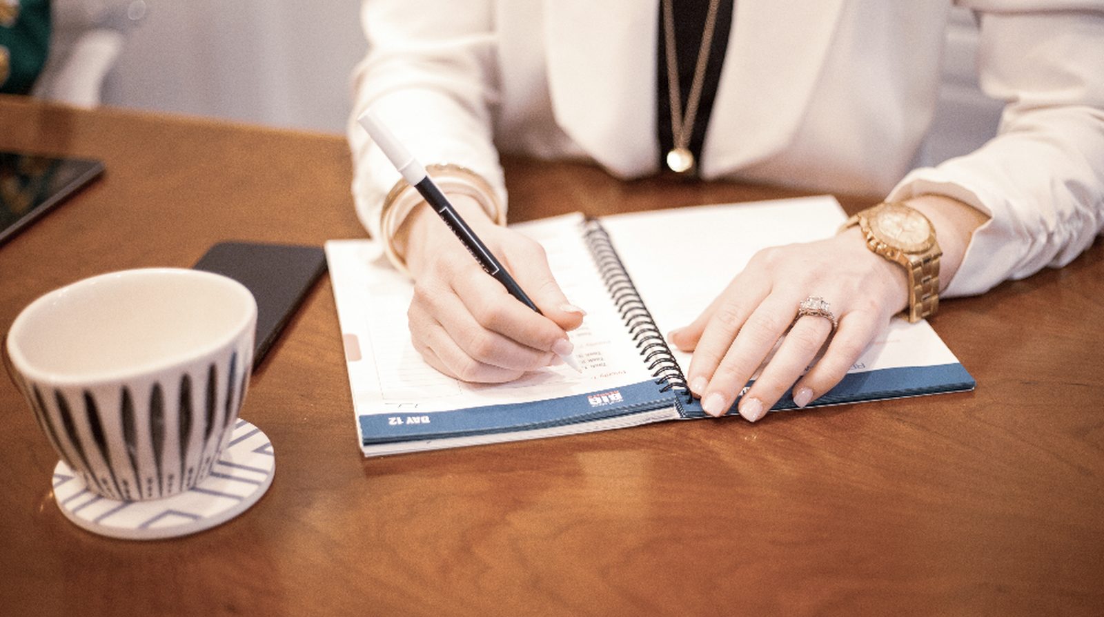 A staff member at a laptop writing micro-copy for a chatbot and button labels